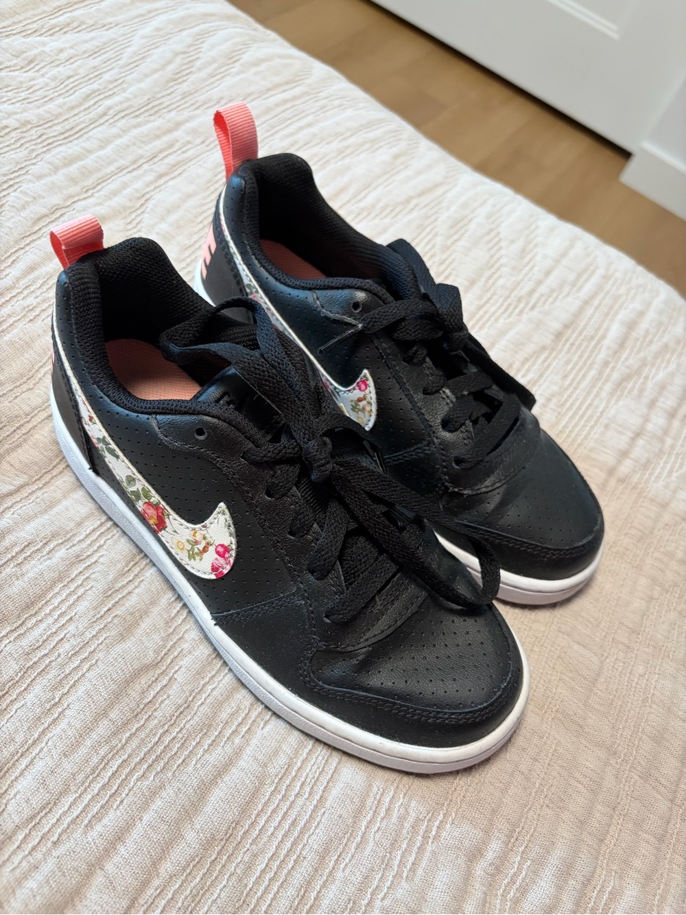 Nike Kids Black Sneakers with Floral Swoosh and Pink Pull Tab